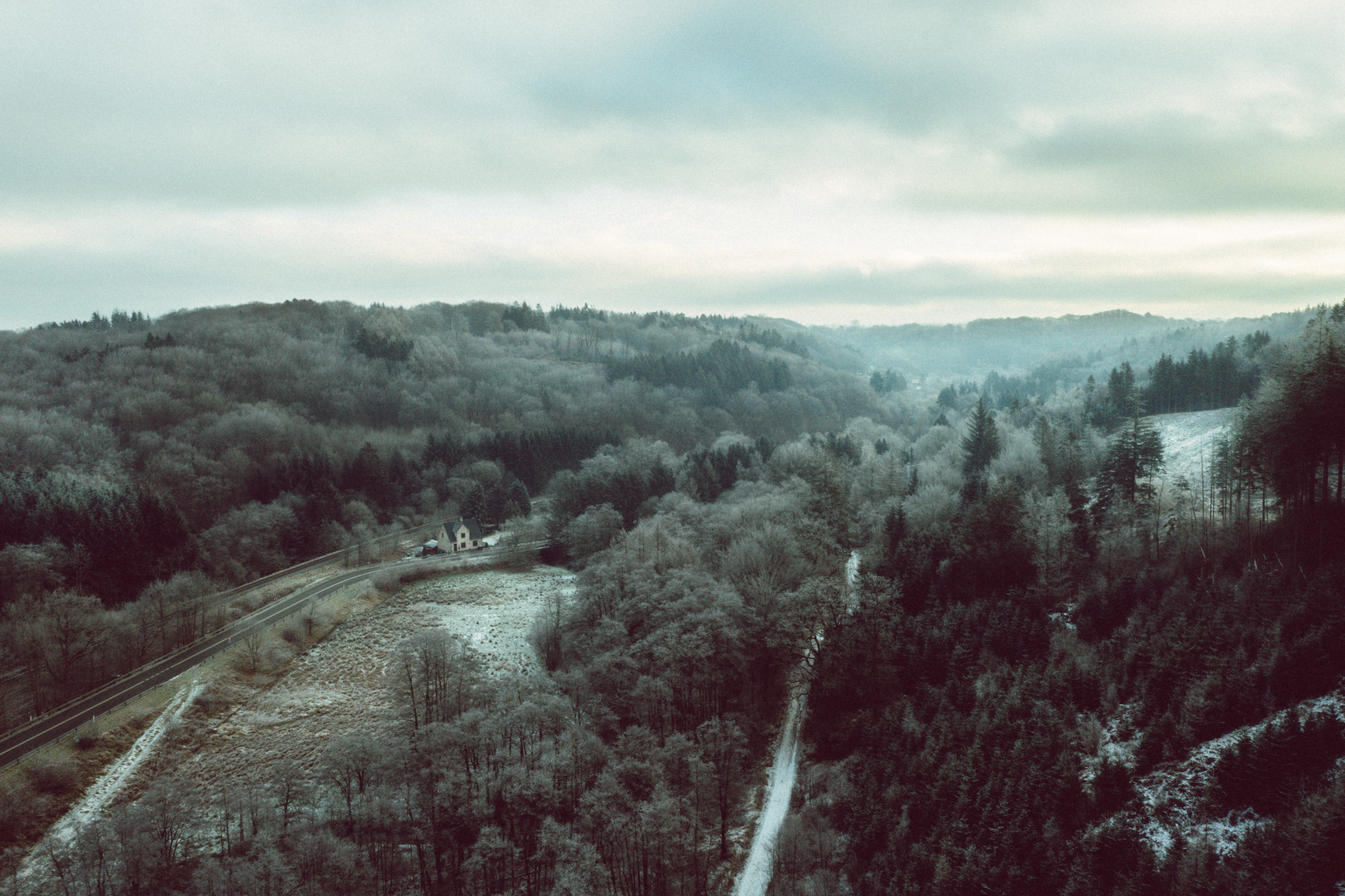 Drone image of Grejsdalen, where the fog comes in over the valley
