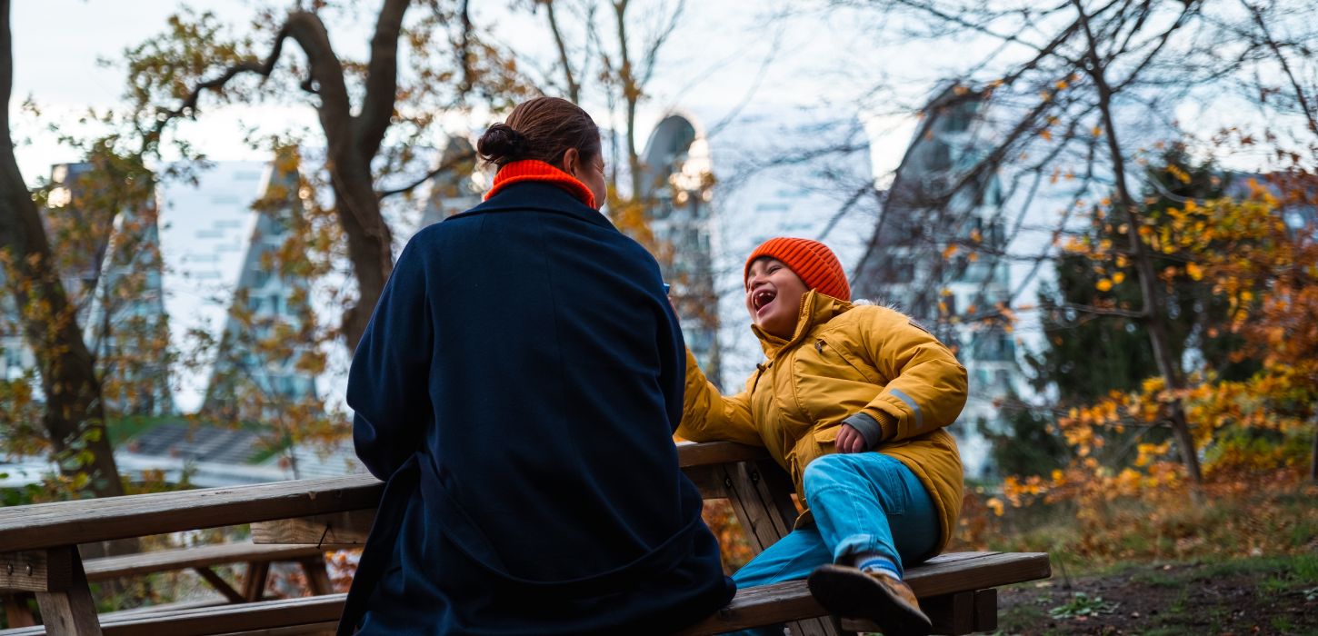  Mother and child in Nørreskoven in Vejle in autumn with a view over Bølgen and the harbourfront
