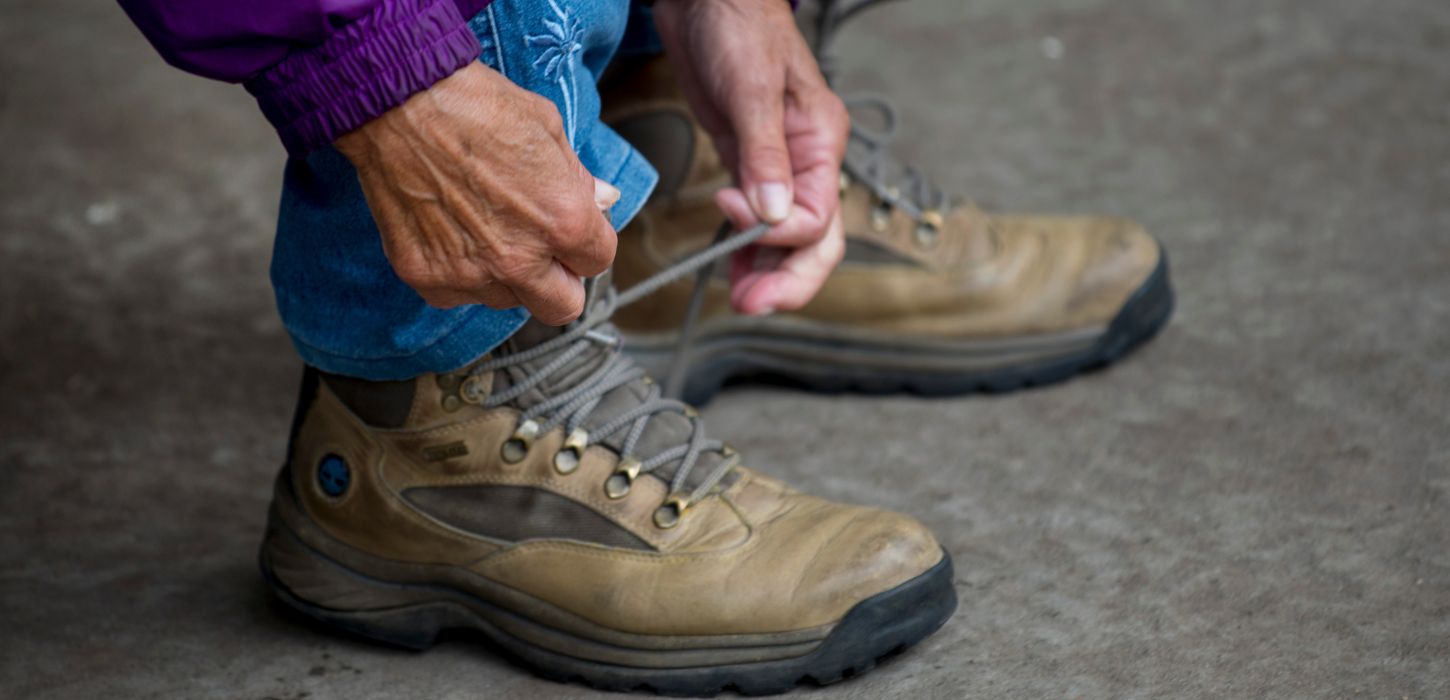 Woman ties her hiking boots and is ready to go for a walk by Vejle