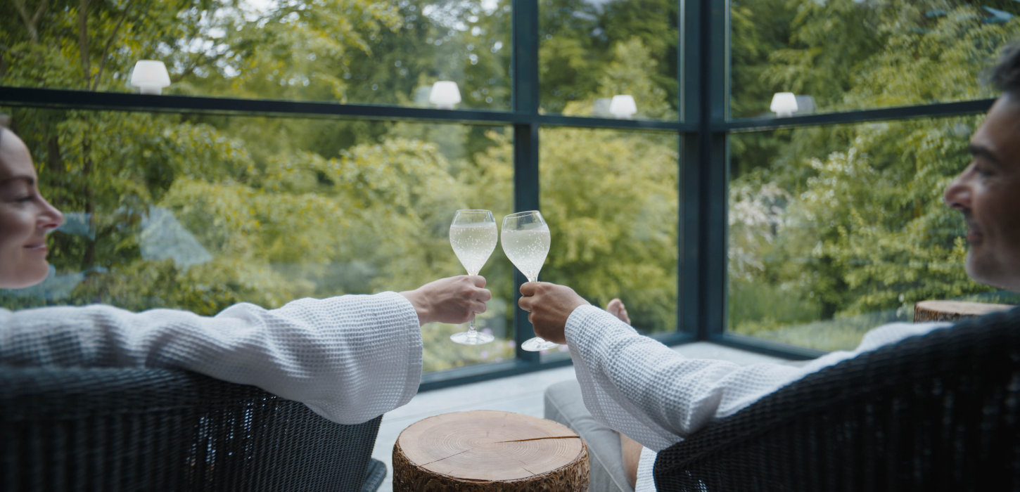 A couple enjoying a glass of bubbly at Hotel Vejlefjord