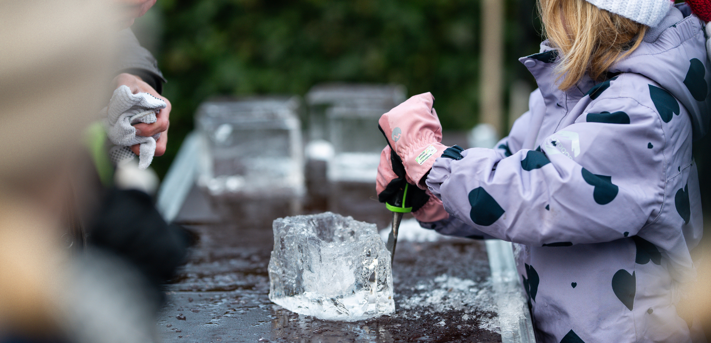 Girl making an ice sculpture at the Ice Sculpture Festival in Give