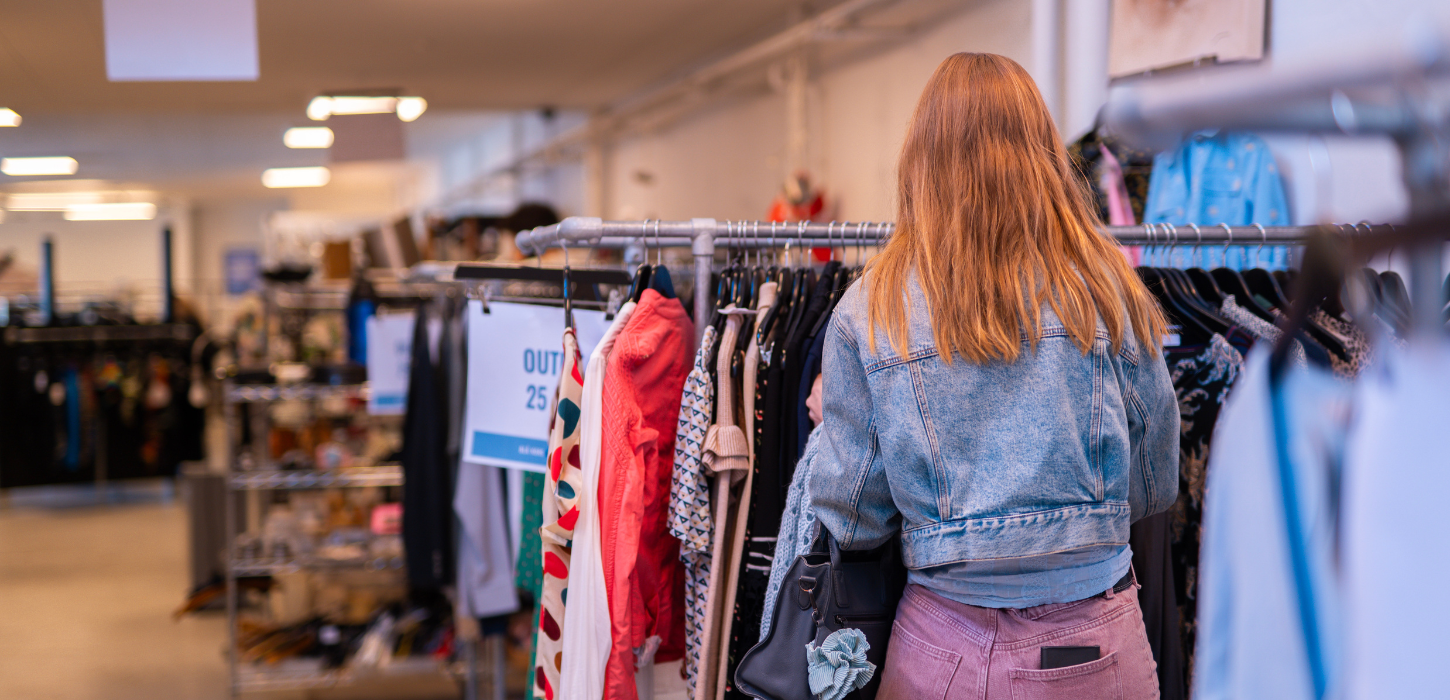 Young woman looking at clothes in one of Vejle’s second-hand shops