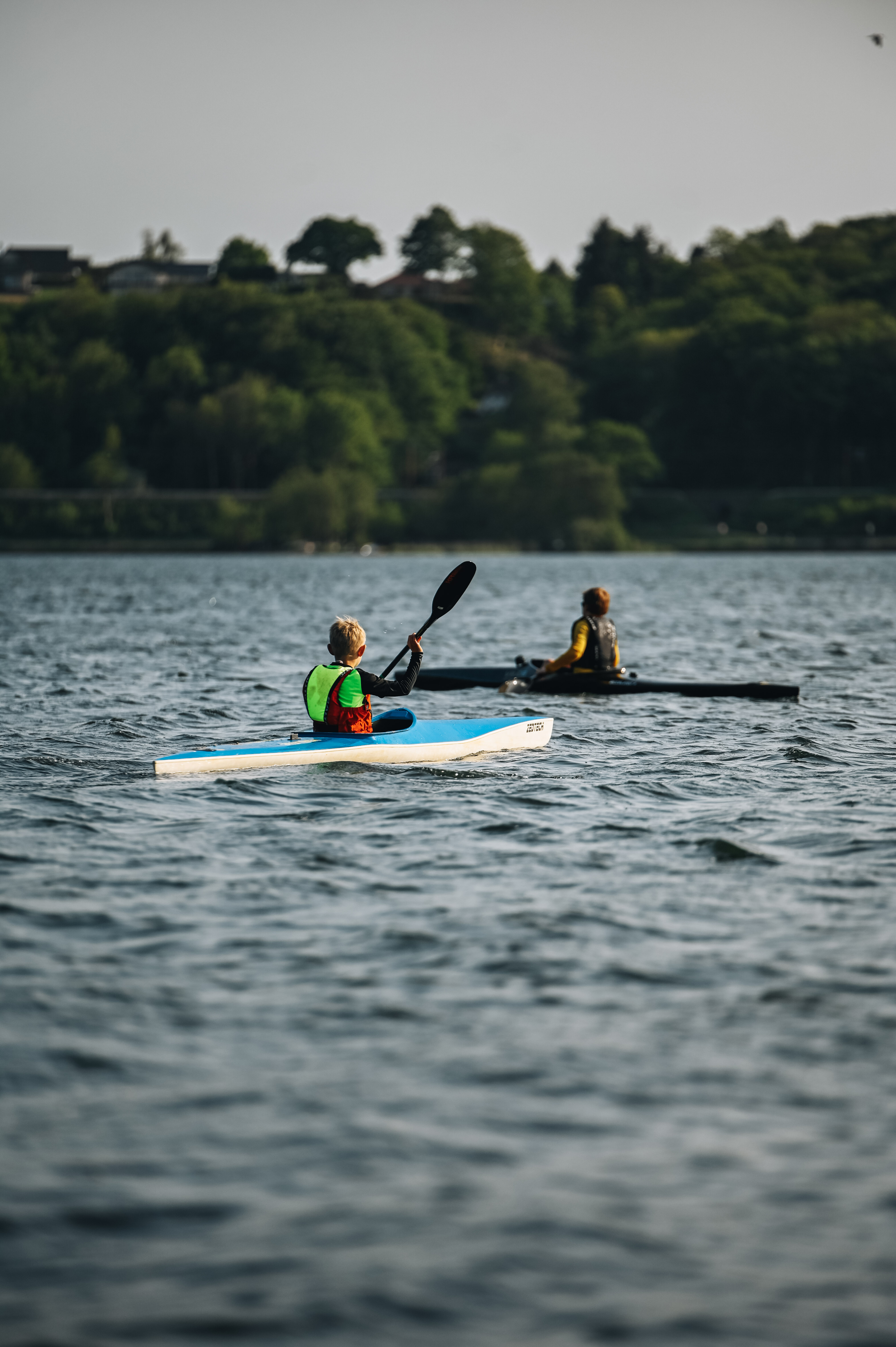 Two children in a kayak on a summer day on Vejle Fjord
