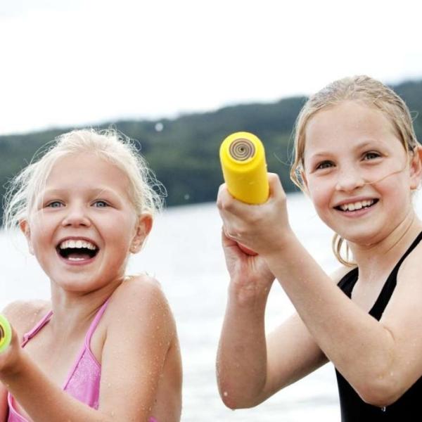 Girls at Tirsbæk Beach playing with water pistols
