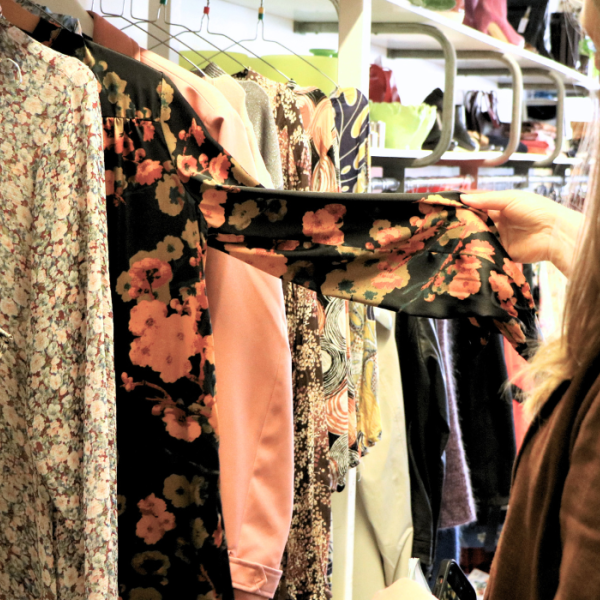 A person looks at clothes in a thrift shop in Give