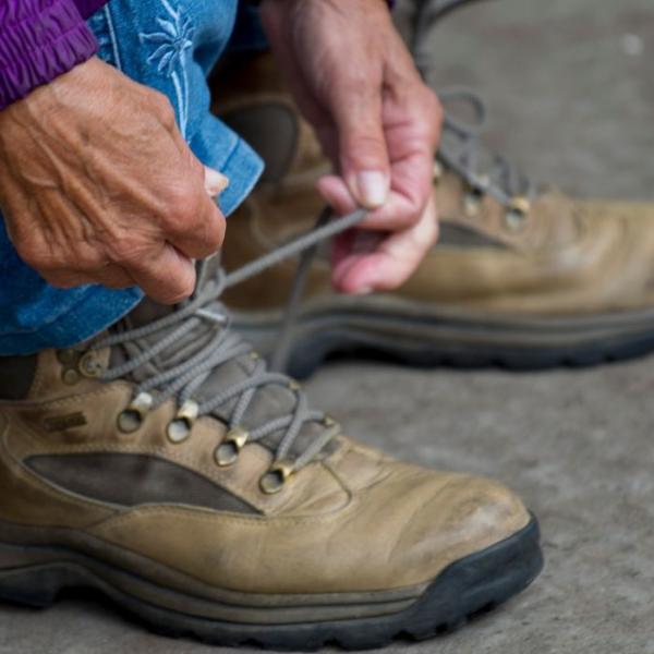 Woman ties her hiking boots and is ready to go for a walk by Vejle
