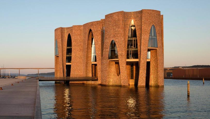 Fjordenhus with sun on it at sunset
