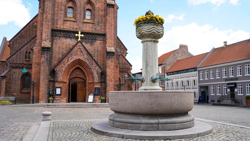 Out in front of St. Nicolai Church in Vejle with the fountain in the foreground