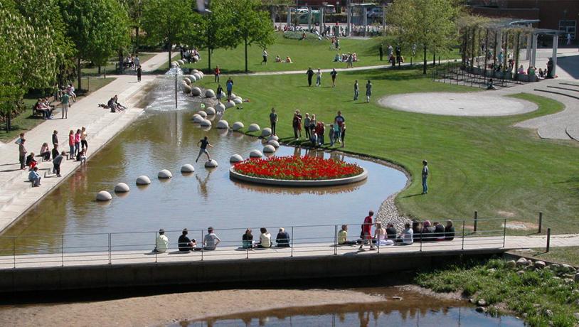 People are in the Byparken city park in Vejle on a summer day