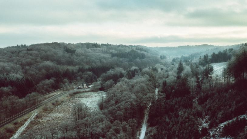 Drone image of Grejsdalen, where the fog comes in over the valley