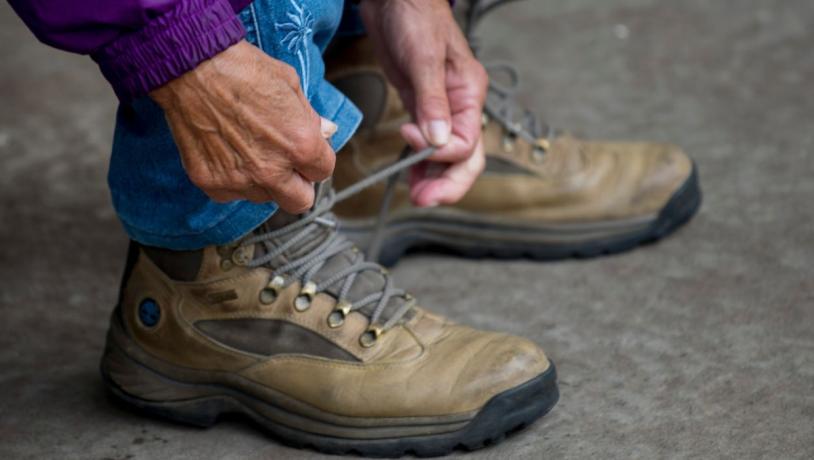 Woman ties her hiking boots and is ready to go for a walk by Vejle