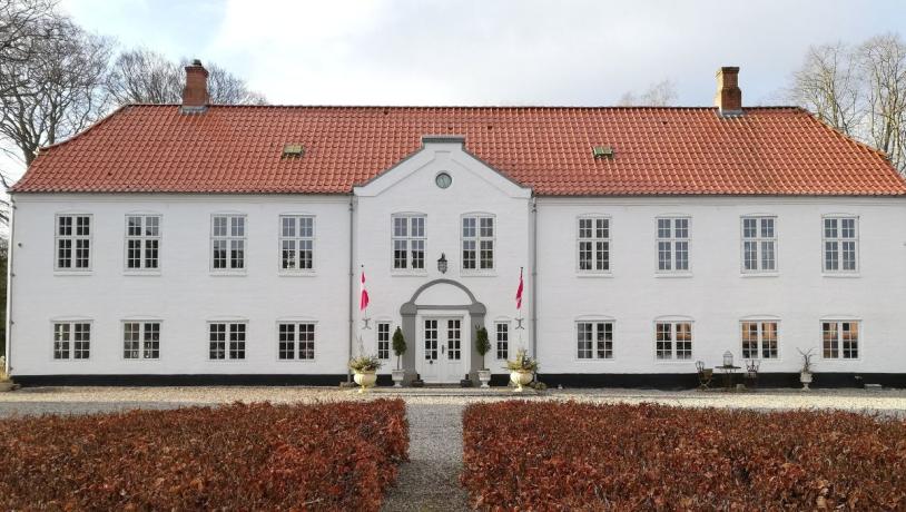 The main building of Haughus Manor seen from the courtyard on a spring day