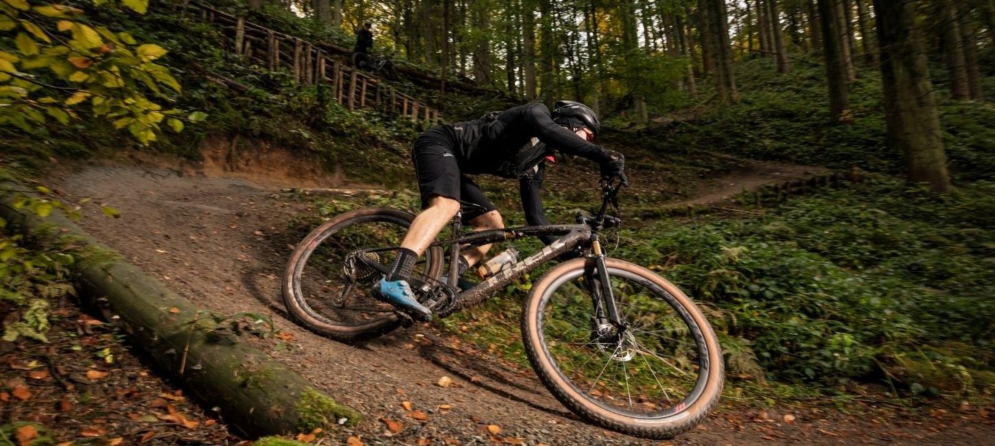 Cyclist on the way down the mountain bike hill in Nørreskoven Forest