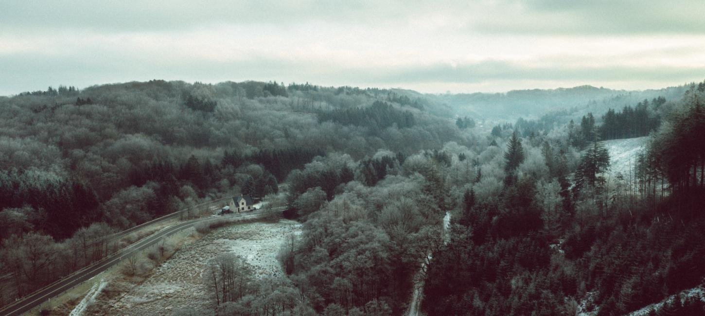 Drone image of Grejsdalen, where the fog comes in over the valley