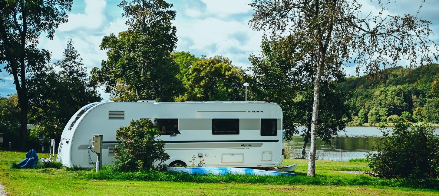 A caravan is parked by Fårup Lake near Jelling
