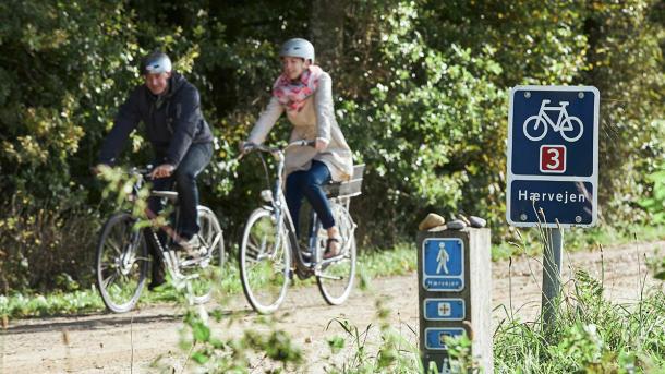 Two cycling on Hærvejen close to the source of Gudenåen