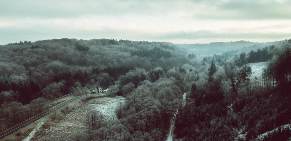 Drone image of Grejsdalen, where the fog comes in over the valley
