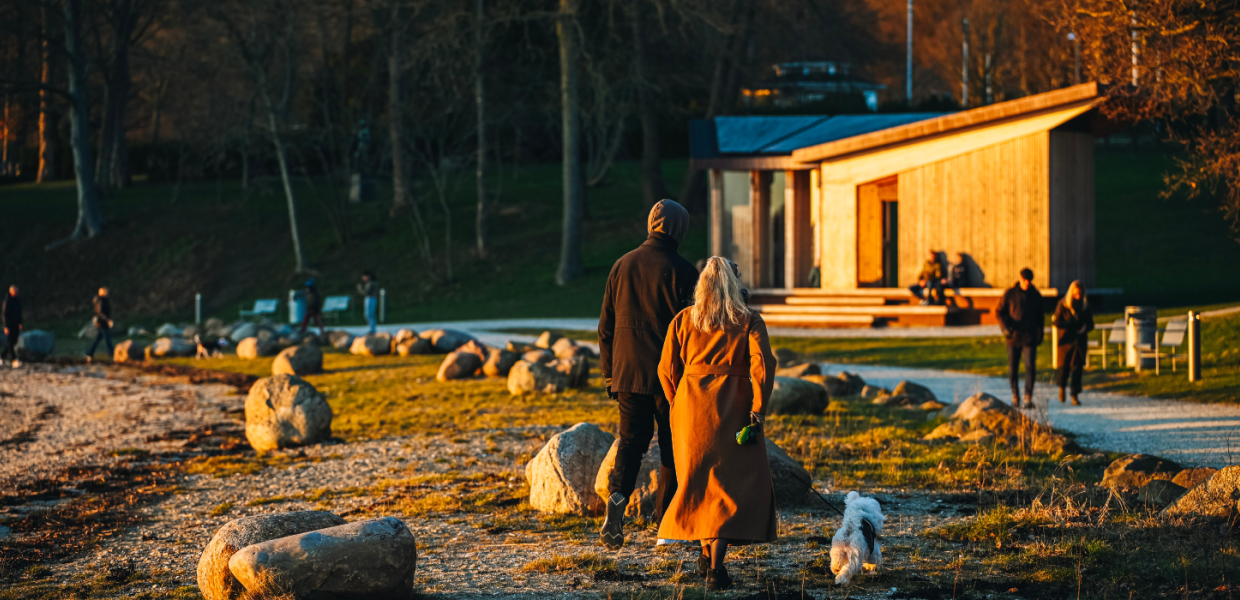 Couple taking a walk in Skyttehushaven by Vejle Fjord on a spring day