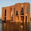 Fjordenhus with sun on it at sunset