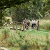 Family of two adults and three children cycling along Bindeballestien near Vingsted