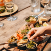 A couple enjoys tapas and a glass of wine on a romantic date in Torvehallerne