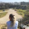 Person takes a break at Tørskind Gravel and enjoys the view of the gravel pit and the sculpture