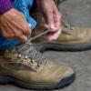 Woman ties her hiking boots and is ready to go for a walk by Vejle