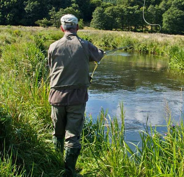 An angler on a fishing trip by Vejle Å