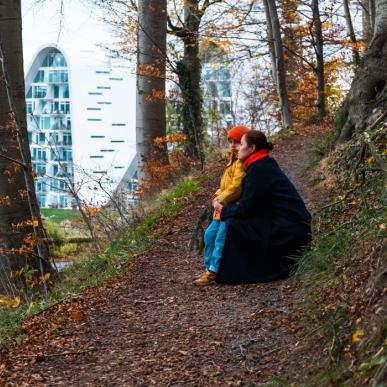 Mother and child on a walk in Nørreskoven in Vejle in autumn with a view of Bølgen and the waterfront