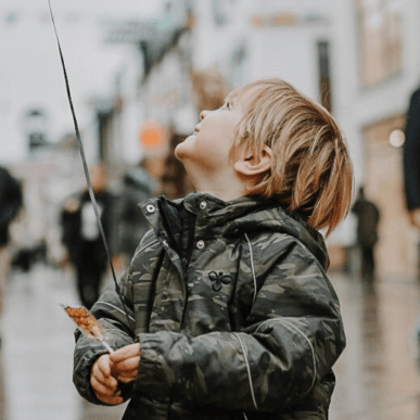 Boy stands with balloon in Vejle pedestrian street for Halloween