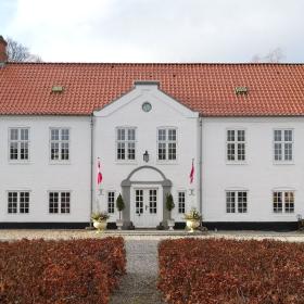 The main building of Haughus Manor seen from the courtyard on a spring day