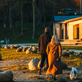 Couple taking a walk in Skyttehushaven by Vejle Fjord on a spring day
