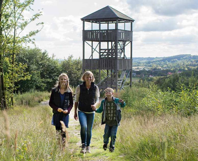 Family visits the observation tower in Østengård