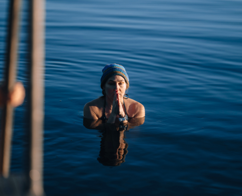 Winter swimmers in the water at Tirsbæk Beach by Vejle Fjord