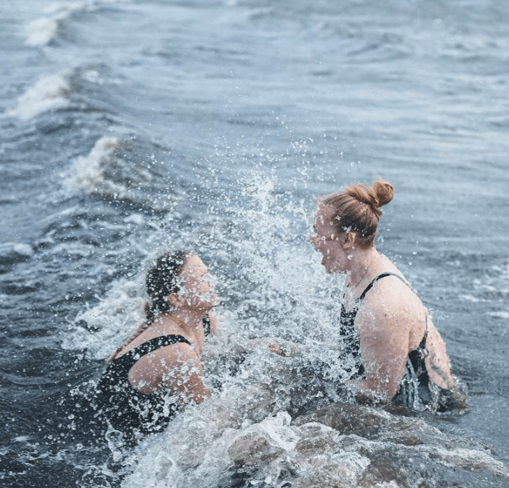 Two women take a winter bath at Tirsbæk Strand