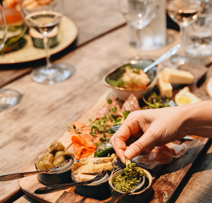 A couple enjoys tapas and a glass of wine on a romantic date in Torvehallerne
